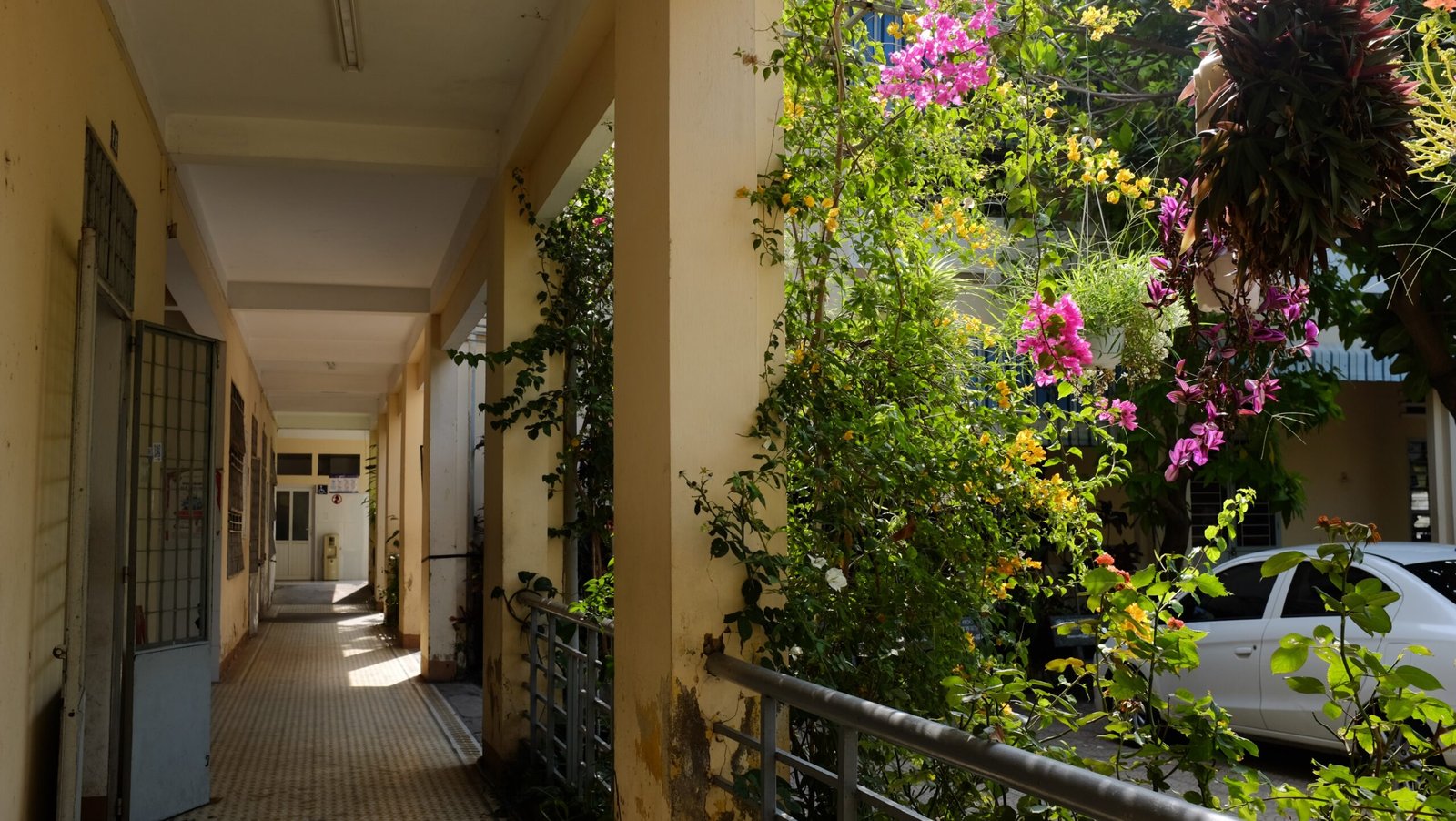 a long narrow hallway with a car parked on the side of it